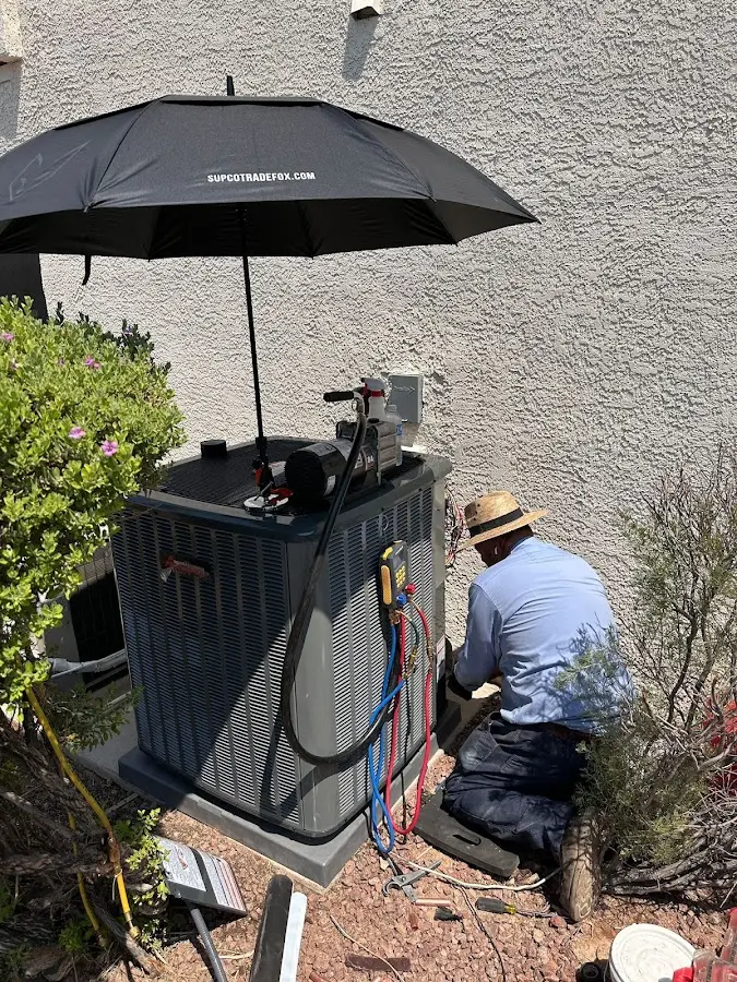 HVAC technician performing outdoor AC maintenance in Spartanburg