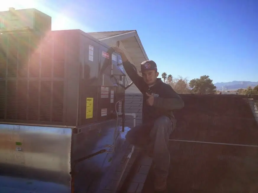 HVAC technician performing HVAC Inspection on a rooftop unit in Spartanburg